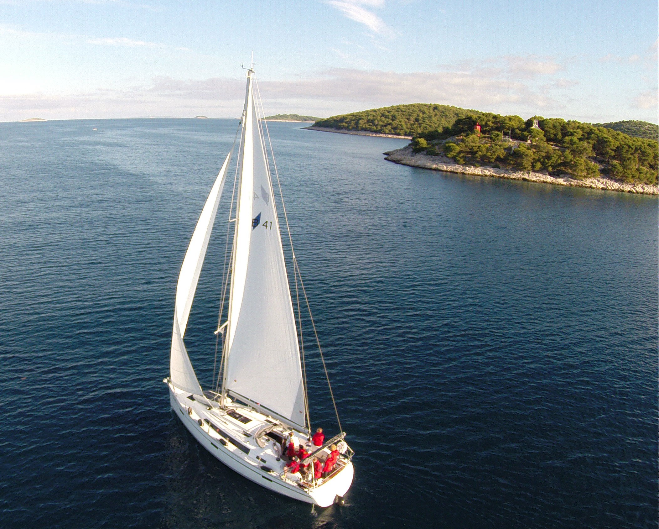 A team aboard a yacht under sail